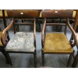 A Victorian pair of mahogany dining chairs with scroll arms and lift out bases