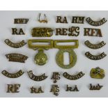 A collection of approximately 40 brass shoulder titles, together with a Coldsteam Guards belt