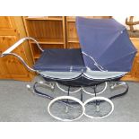 A Silver Cross Wilson pram, c.1977, with blue canvas hood, spoked wheels with white rubber