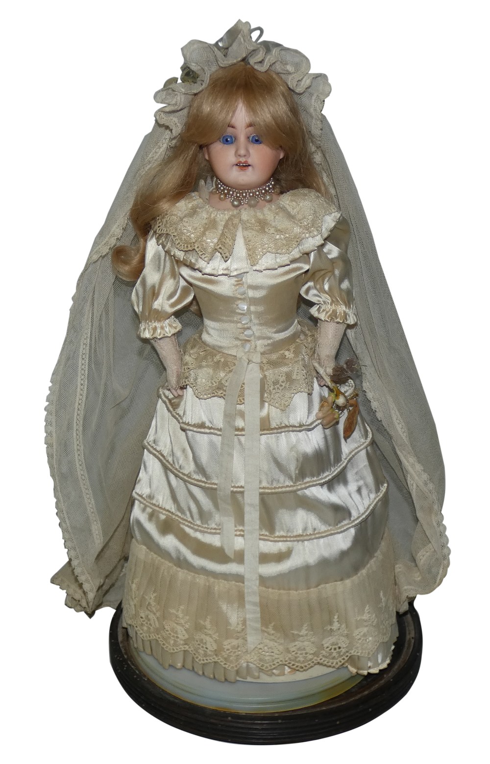 An Armand Marseille German bride doll holding a bouquet of flowers, c.1885, numbered '3097', with