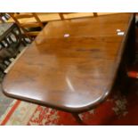 A mahogany drop leaf dining table