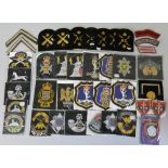 A collection of approximately 40 military cloth and blazer badges.