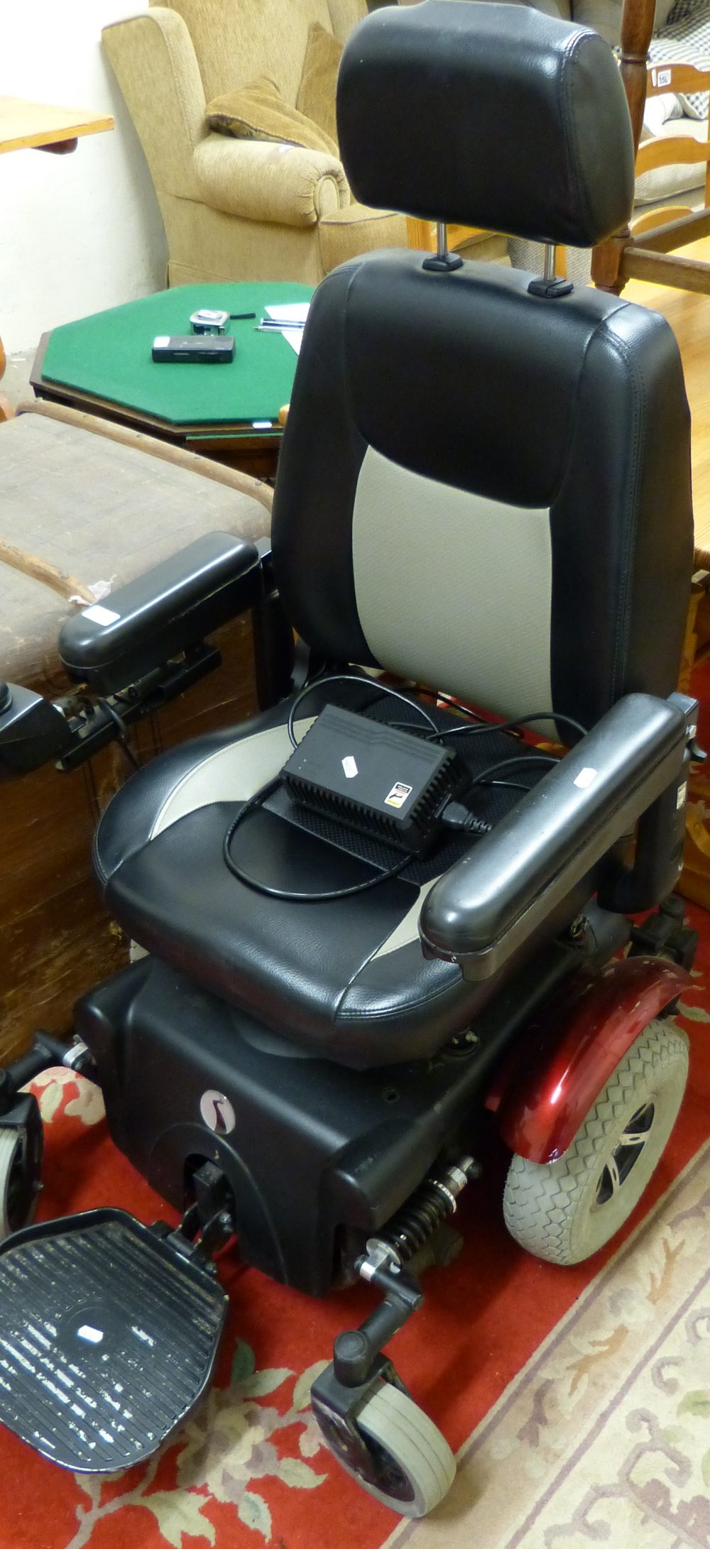 A powered wheelchair from Beechwood mobility together with charger, in good working order