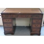 A mahogany kneehole desk, 121 x 62 cm, inset sciver and four drawers to each side and central