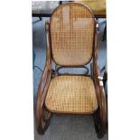 A bentwood rocking chair with cane seat and back