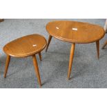 An Ercol elm nest of two pebble tables