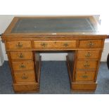 A mahogany knee hole desk, 106 cm x 65 cm, inset scriber and four drawers to each side of central