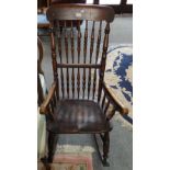 A spindle back rocking elbow chair