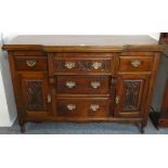 An Edwardian mahogany break front cabinet, central carved frieze draw over two plane examples,