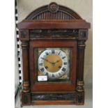 An oak mantle clock with domed top
