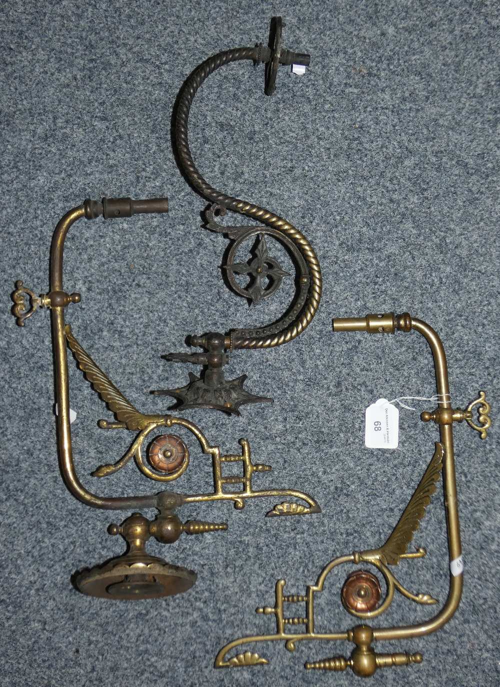 A pair of copper and brass gas wall lights together with another