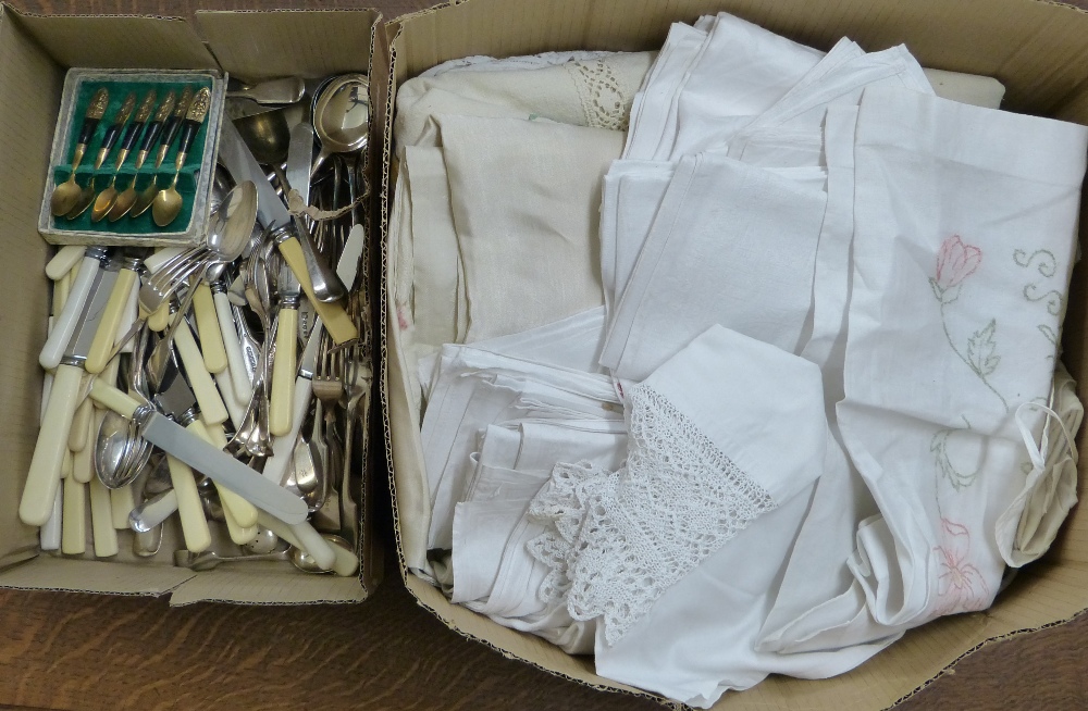 A box of loose and boxed cutlery together with a box of linen (2)