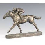 A bronzed figure of a race horse with jockey up, raised on an oval base 20cm h x 28cm w x 7cm d (