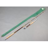 A Hardy Bros. 7' 50lb Class boat fishing rod with detachable butt, contained in a green cloth