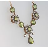 An Edwardian style silver gilt peridot and seed pearl necklace