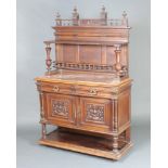 A 19th Century French carved walnut chiffonier the raised back with bobbin turned decoration and