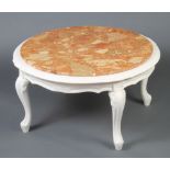 A circular Italian style white painted occasional table with pink veined marble top, raised on