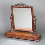 A William IV rectangular plate dressing table mirror contained in a mahogany swing frame raised on