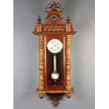 A Vienna style striking regulator with porcelain dial, Roman numerals and grid iron pendulum