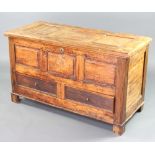An 18th Century elm mule chest of panelled construction and with hinged lid, the base fitted 2