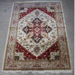 A brown ground and floral patterned Heriz style Belgian cotton carpet with central medallion 280cm x