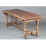 A French rectangular pine refectory table raised on turned supports with H framed stretcher 75cm h x