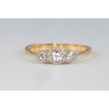 An 18ct yellow gold 3 stone diamond ring 2.5 grams, size M 1/2