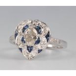 An 18ct white gold Victorian style heart shaped diamond and sapphire ring, the centre pear cut