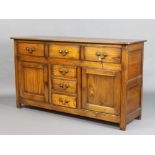 A 17th/18th Century style elm dresser base fitted 3 long drawers above 3 short drawers flanked by