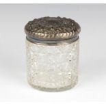 An Edwardian silver topped toilet jar with scroll decoration Sheffield 1903, 8.5cm
