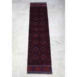 A red and blue ground Meshwani runner with 18 stylised diamonds to the centre 267cm x 64cm