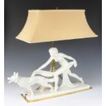 An Art Deco painted ceramic table lamp in the form of a lady with Alsatian, with gilt metal