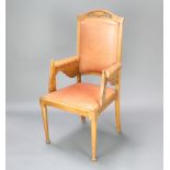 An oak Art Nouveau throne chair with upholstered seat and back raised on turned supports