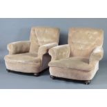 A pair of Victorian Howard style armchairs upholstered in mushroom buttoned back material, raised on