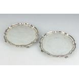 A pair of silver card trays with Chippendale rims on scroll feet, Sheffield 1938 by James Dixon