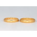 Two 18ct yellow gold wedding bands, size P and Q, 7.4 grams
