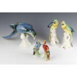 A Royal Dux figure of a parrot 22cm, 2 Karl Ens parrots on rocky bases 25cm and a pair of German