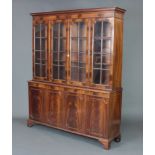 A Georgian style mahogany bookcase on cabinet, the upper section with moulded cornice fitted