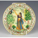 A Persian painted and gilt decorated marble dish depicting a lady feeding an exotic bird 15cm