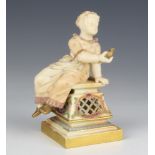A Royal Worcester figure of a young lady holding a bird sitting on a plinth with reticulated base