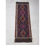 A Suzni Kilim runner with 5 stylised diamonds to the centre 233cm x 74cm