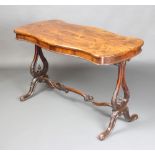 A Victorian shaped rosewood library/centre table raised on pierced lyre shaped supports with an H