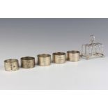A silver 5 bar toast rack with ball feet Birmingham 1938, 5 silver napkin rings, 306 grams