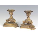 A pair of Regency style stub bronze candlesticks raised on triform bases 13cm x 10cm x 12cm