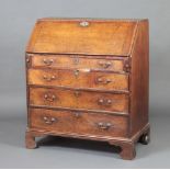 A Georgian oak bureau, the fall front revealing a fitted interior above 4 long graduated drawers