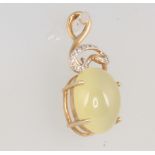 A 9ct yellow gold hardstone and diamond pendant