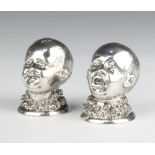 A pair of Victorian cast silver novelty condiments in the form of 2 boys with ruff collars, London