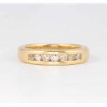 An 18ct yellow gold channel set diamond ring 5.7 grams, size L