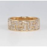 A 9ct yellow gold Greek key pattern diamond set ring size O 1/2, 3.5 grams