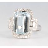 An 18ct white gold aquamarine and diamond dress ring, the emerald cut stone approx. 7.29ct